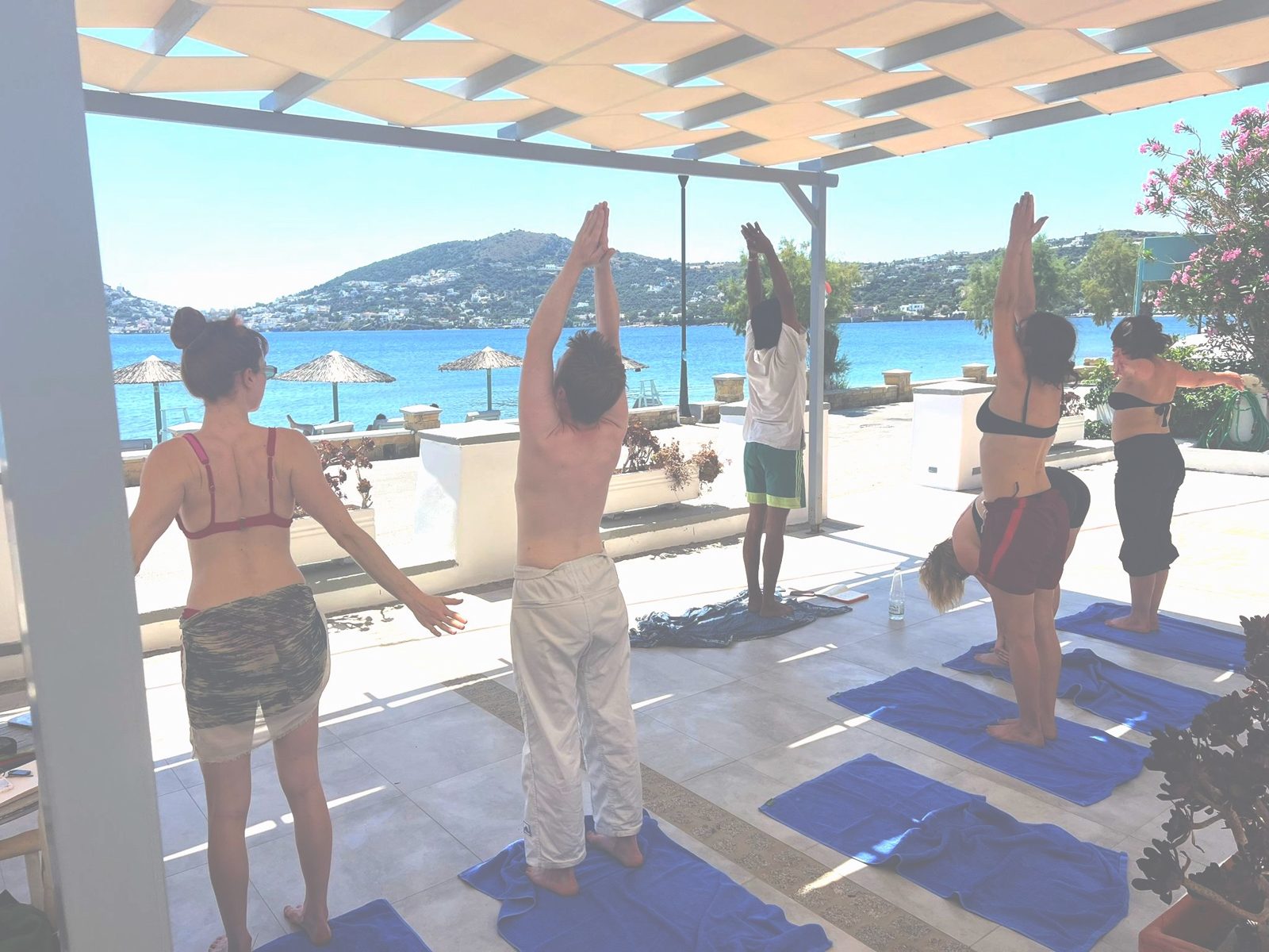 Group yoga by the sea on a retreat